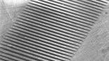 close-up view of riblets, which are microscopic grooves that reduce friction drag on the aircraft’s surface.