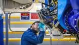 worker working on 777-8F wing spar composite plies