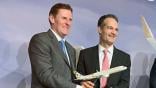 AerCap’s Peter Anderson and Etihad CEO Antonoaldo Neves hold a model of the Etihad A321LR at the delivery ceremony