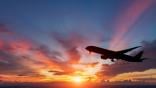 colorful sunset with the silhouette of a passenger plane