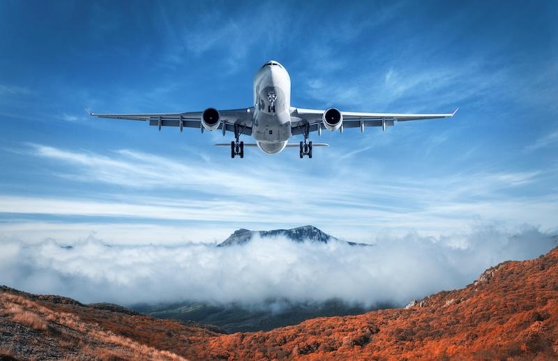 generic airplane over mountain and cloud