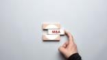 The phrase "M&A" written on wooden blocks