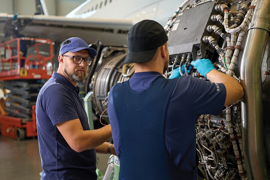 Two technicians working on aircraft part