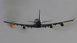 an airplane inflight with one engine on fire
