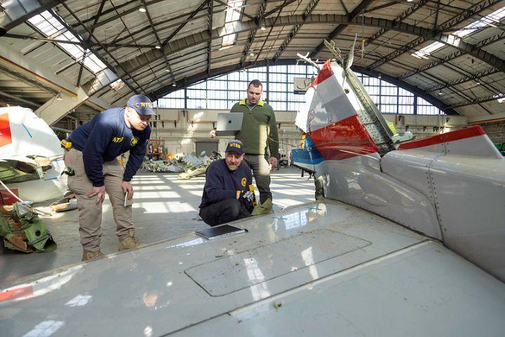 NTSB investigators look at wreckage.