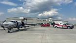 An aircraft and a Williston ambulance at Overland Aviation.  