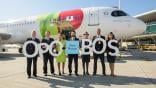 airline workers standing in front of TAP plane celebrating porto-boston route
