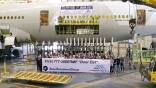 Mammoth Freighters employees in front of a 777-300ERMF)